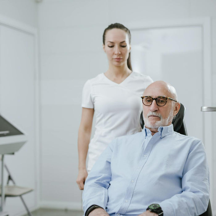 A doctor and senior patient in a modern medical clinic setting.