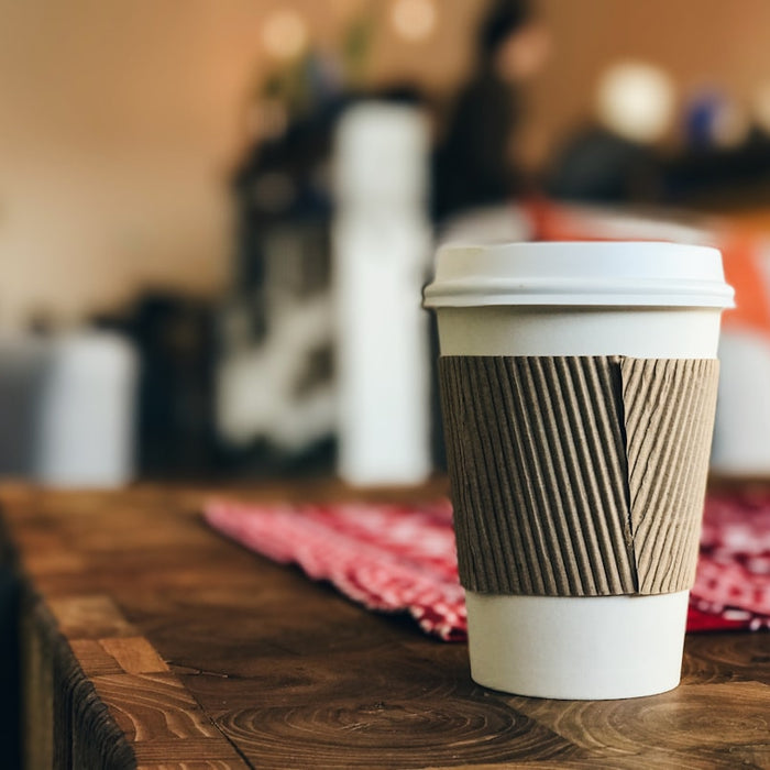 white plastic cup on brown surface