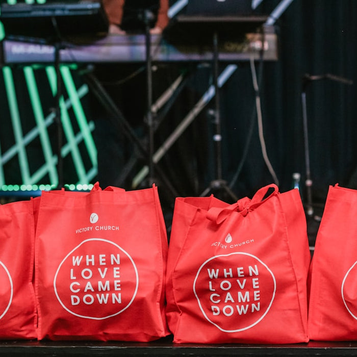 four red fabric tote bags