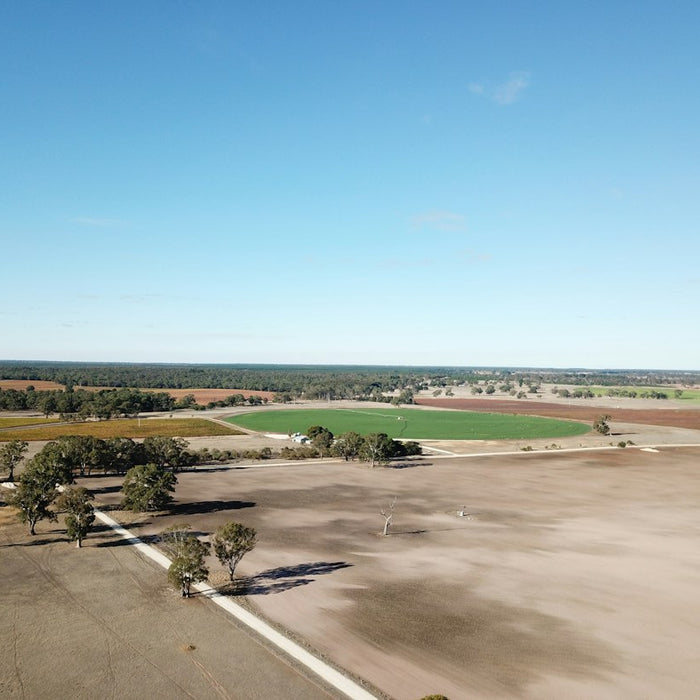 grey concrete field under blue sky