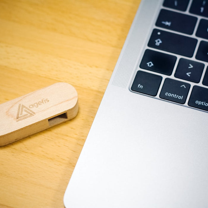 brown thumb drive beside MacBook