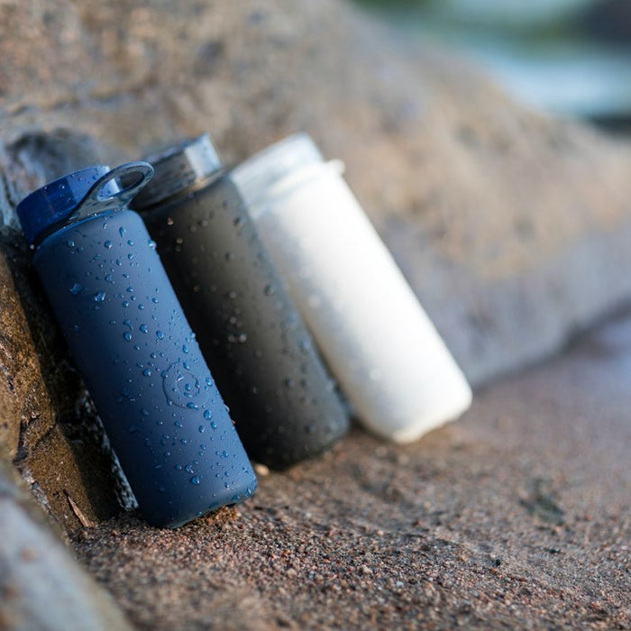 black and white plastic containers on brown sand