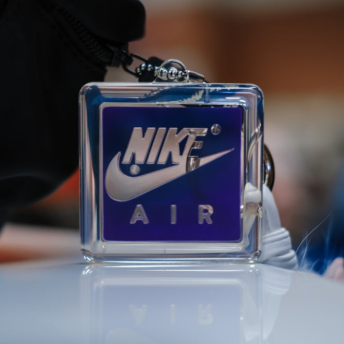 a nike air keychain sitting on top of a table