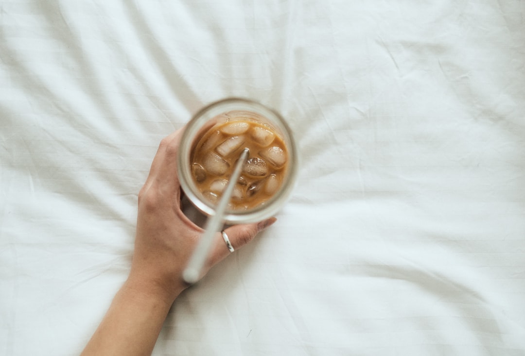 person holding white ceramic mug with coffee
