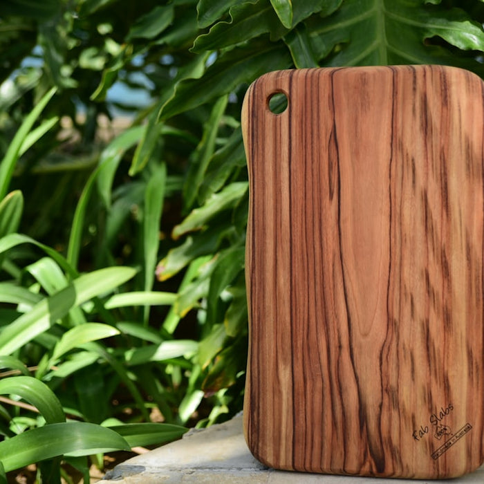 a wooden case sitting on top of a stone wall