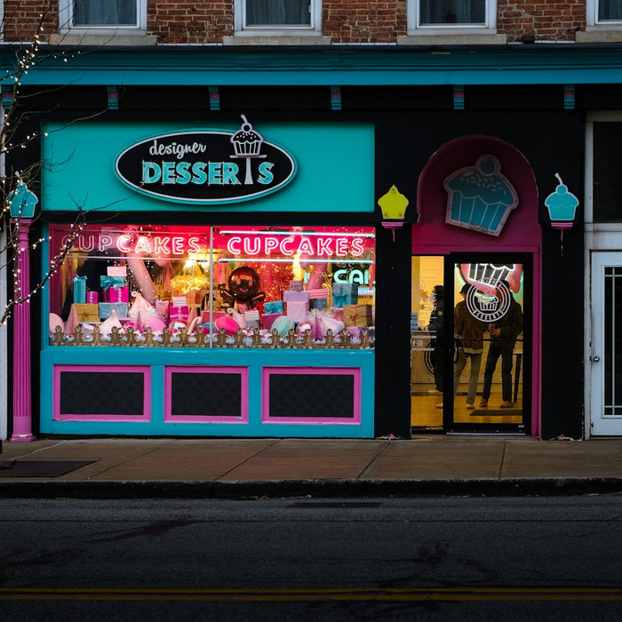 a store front with a neon green and pink window