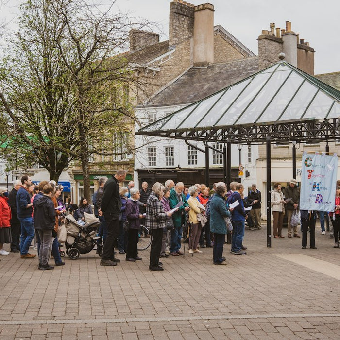 a crowd of people standing around a building