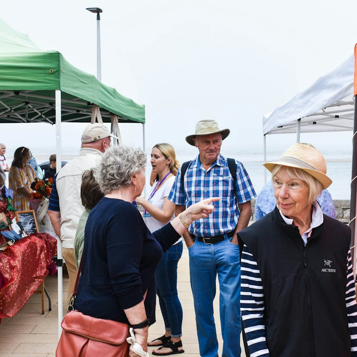 a group of people at an outdoor market