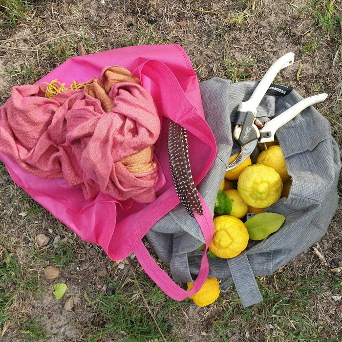 a person lying on the ground with a bag of fruit