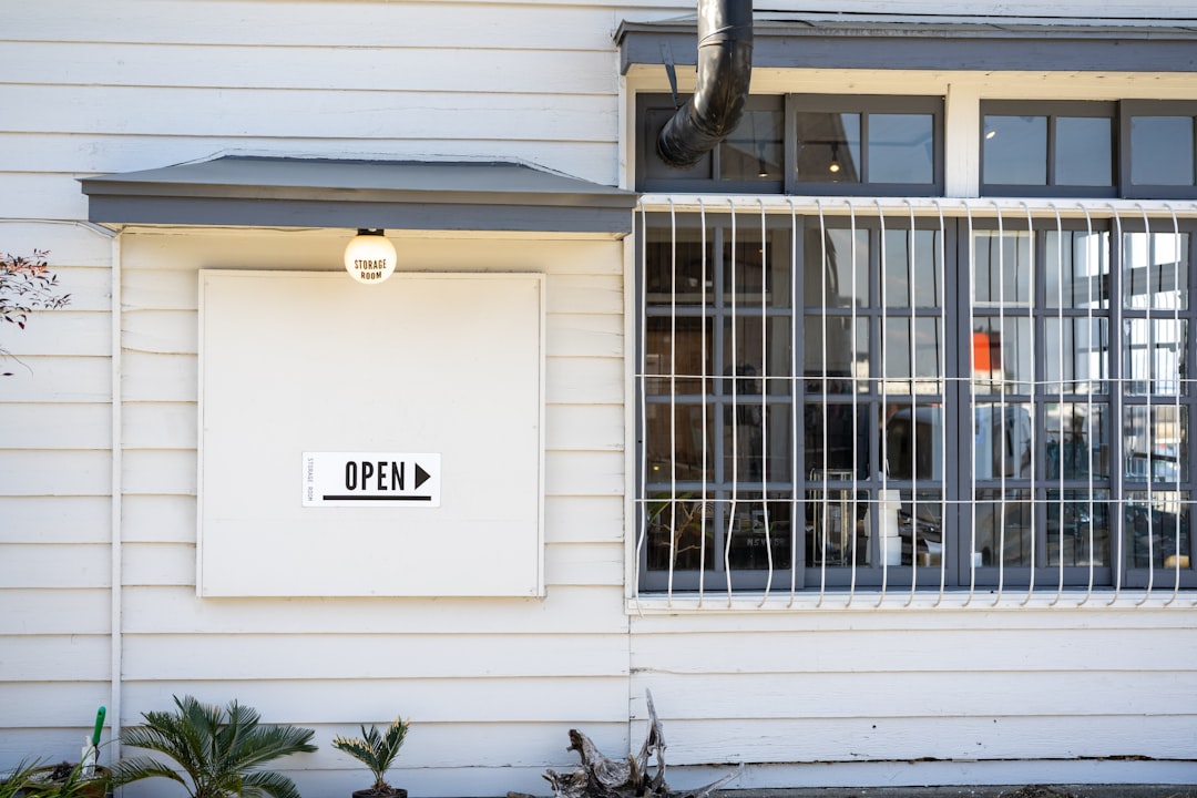 a white building with a window and a sign on it