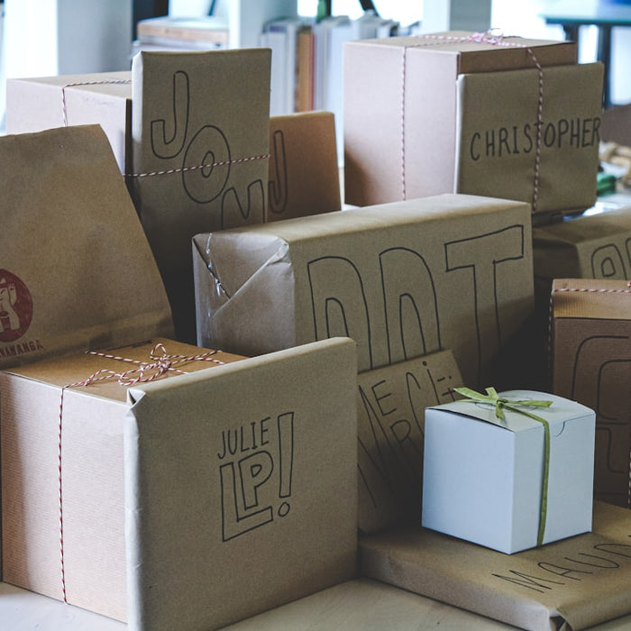 a pile of brown paper bags sitting on top of a table