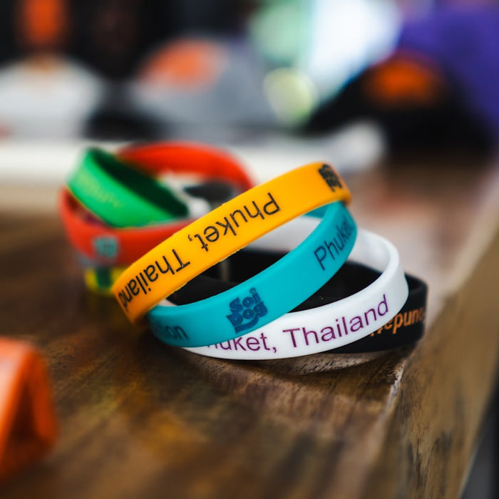a group of bracelets sitting on top of a wooden table