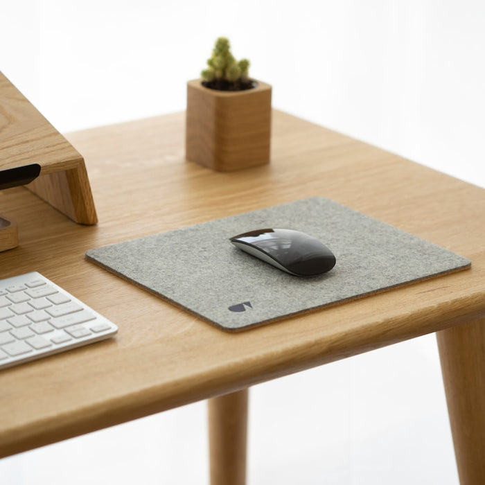a desk with a computer mouse and keyboard on it