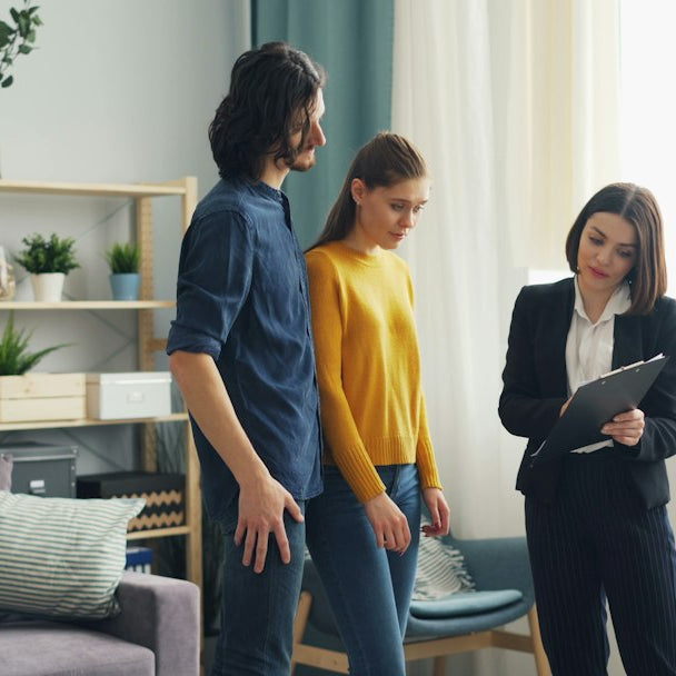a man and a woman standing in a living room