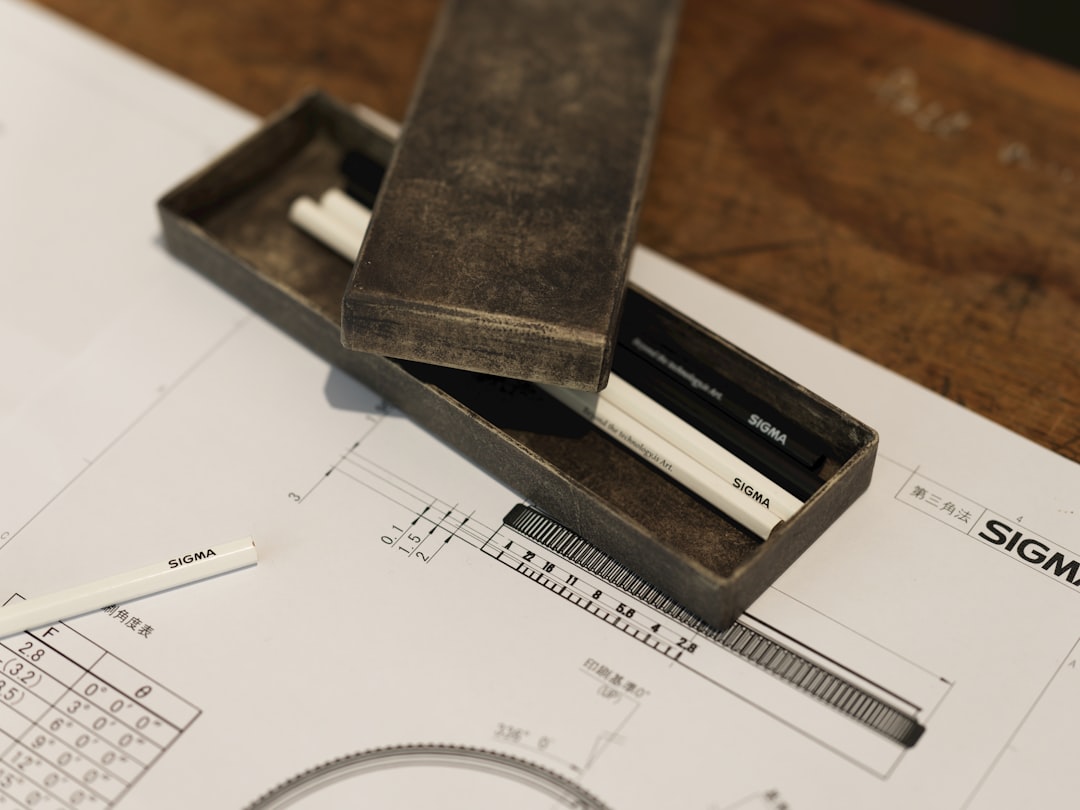 A pencil and ruler sitting on top of a piece of paper