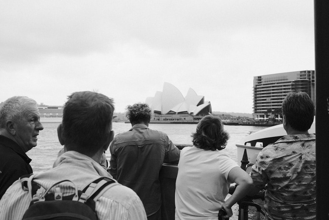 People are looking at the sydney opera house.