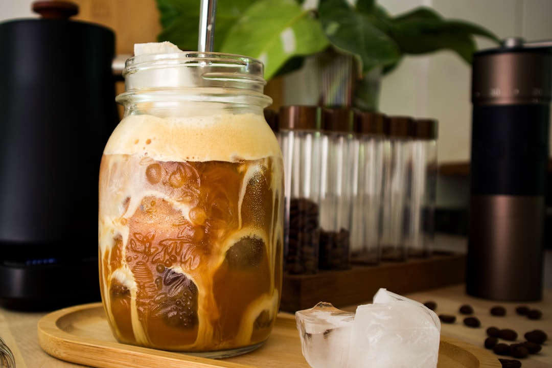 Iced coffee is being made in a jar.