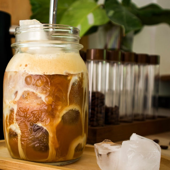 Iced coffee is being made in a jar.