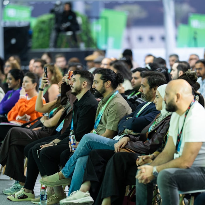 Diverse audience attentively listening at a conference event.