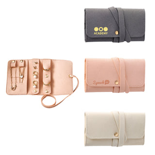 Synthetic Leather Jewellery Bag - A synthetic leather jewellery bag displayed in pink, grey, and cream with gold accents and a logo.