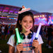 Custom Felt Spring Hair Clip - A girl holds two glowing light sticks, one green and one purple, wearing headphones at a vibrant outdoor event.