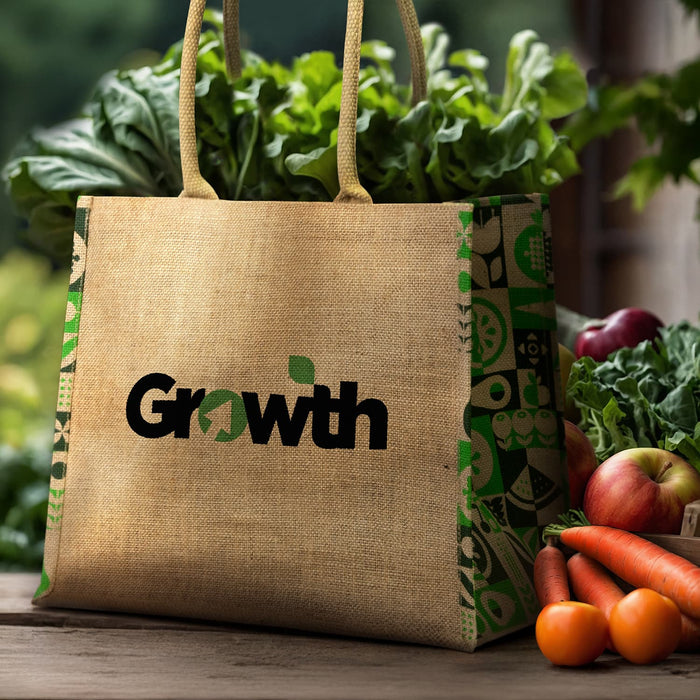 Torino Jute Tote Bag - A jute tote bag in natural tones with a colourful patterned design and handles, surrounded by fresh vegetables and fruit.