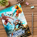Scribe Full Colour Note Pad - Medium - A medium full-colour notepad featuring extreme sports visuals, with a coil binding, placed on a wooden desk with stationery.