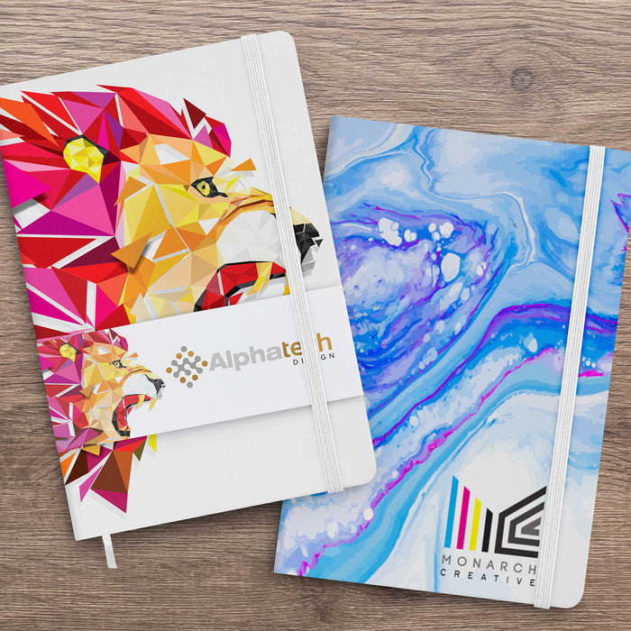 Supra Full Colour Notebook - Two notebooks displayed side by side, one with a colourful lion design and the other in blue marbled pattern, both featuring logos.