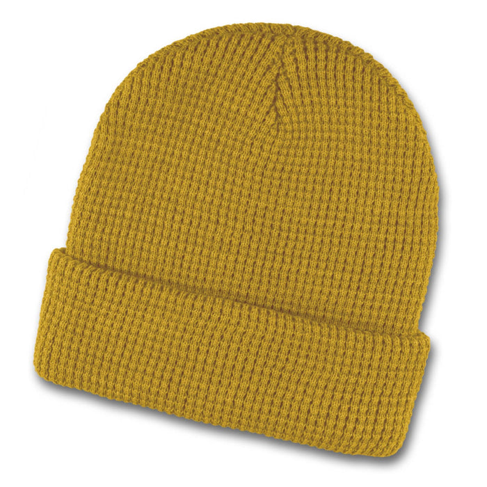 Galway Waffle Beanie - A mustard yellow waffle beanie featuring a ribbed texture and a folded cuff. It has a logo present.