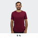 TRENDSWEAR Element Unisex T-Shirt - A unisex TRENDSWEAR Element t-shirt in burgundy, featuring a logo, worn by a smiling model.