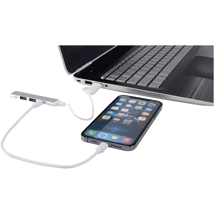 Alkaid 4-Port Recycled Aluminium USB-A & Type-C Hub w/ Dual Input - A 4-port USB hub in silver connects to a laptop with a phone attached, featuring USB-A and Type-C inputs.