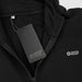 Swiss Peak Urban Hoodie - A black hoodie featuring a zip and a tag, with a small branding logo on the front.