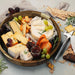 Keepsake Platter Tray - A wooden platter tray filled with various cheeses, grapes, crackers, and a jar of jam, styled with herbs.