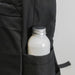 Oceana Recycled Backpack - A black backpack pocket holds a silver-capped drink bottle, featuring a textured fabric design.
