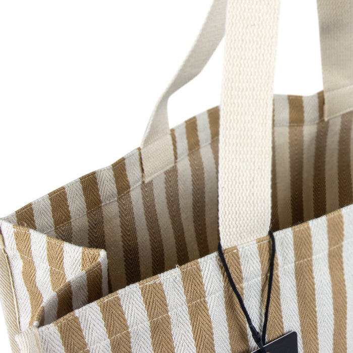 Keepsake Beach Tote Bag - A striped beige and white tote bag with sturdy handles and an interior pocket, featuring a logo.