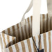 Keepsake Beach Tote Bag - A striped beige and white tote bag with sturdy handles and an interior pocket, featuring a logo.