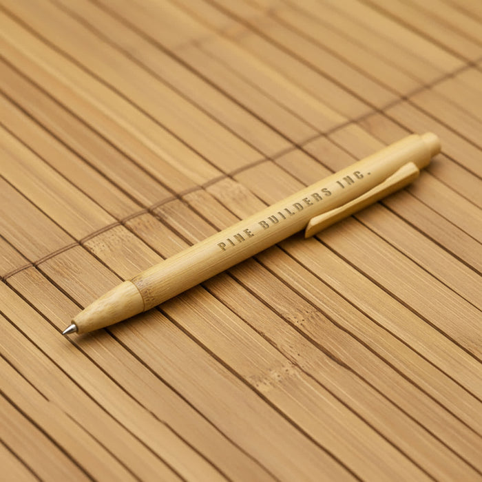 Moso Bamboo Pen - A bamboo pen with a natural finish, featuring a clip and branding. The background is made of bamboo material.
