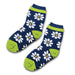 Custom Cozy Socks - A pair of cosy navy socks featuring white daisies and bright green detailing, with a logo present.
