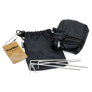 Frontier Torrent Camping Blanket - A black camping blanket and pouch with three silver stakes included. The pouch has a branding logo.