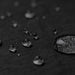 Byron 14" GRS Recycled City Laptop Backpack 16L - A close-up of water droplets on a textured black fabric, highlighting its water-resistant properties.