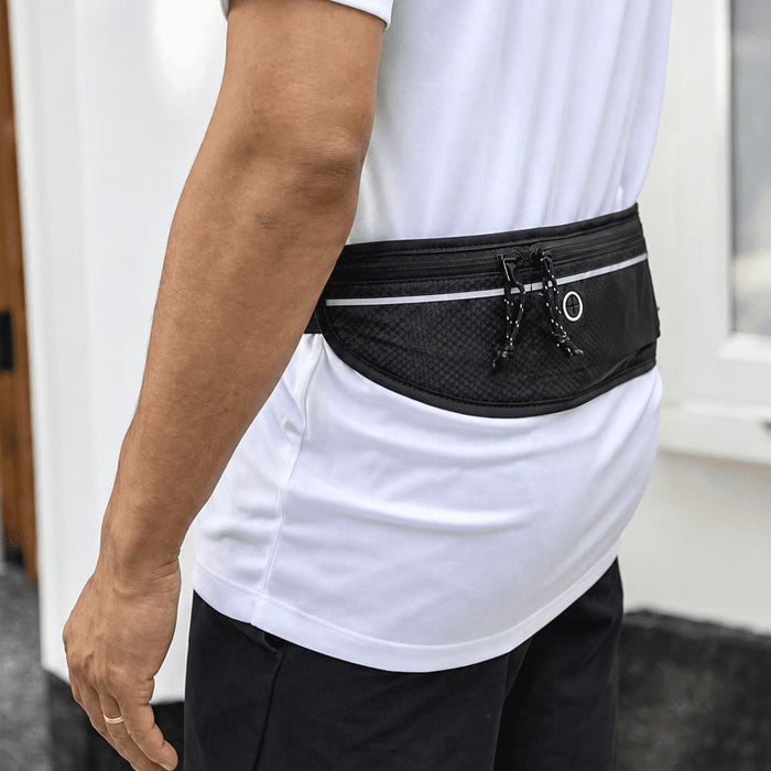 Varyon GRS Recycled Running Waist Pack - A black recycled running waist pack with a textured finish, featuring drawstrings and a logo, worn at the waist.