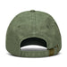 Vintage Washed Cap - A green vintage washed cap featuring a buckle closure and an open back design. It has a simple branding logo.