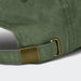 Vintage Washed Cap - A vintage washed green cap featuring a metal buckle and adjustable strap at the back.