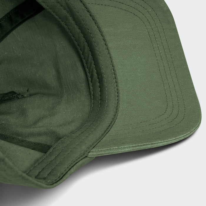 Vintage Washed Cap - A vintage washed cap in olive green with a structured brim and internal stitching details, featuring a logo.