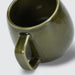 Keepsake Moda Coffee Mug – Set of 2 - A green ceramic coffee mug with a unique handle design, featuring a glossy finish. Set of two available.