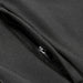 Swiss Peak Urban Unisex Softshell Jacket - A close-up of a black softshell jacket featuring a zippered pocket and sleek fabric texture.