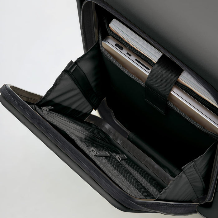 Kadi Carry-On Suitcase - Business - A black carry-on suitcase interior featuring compartments for a laptop and documents. It includes a logo.