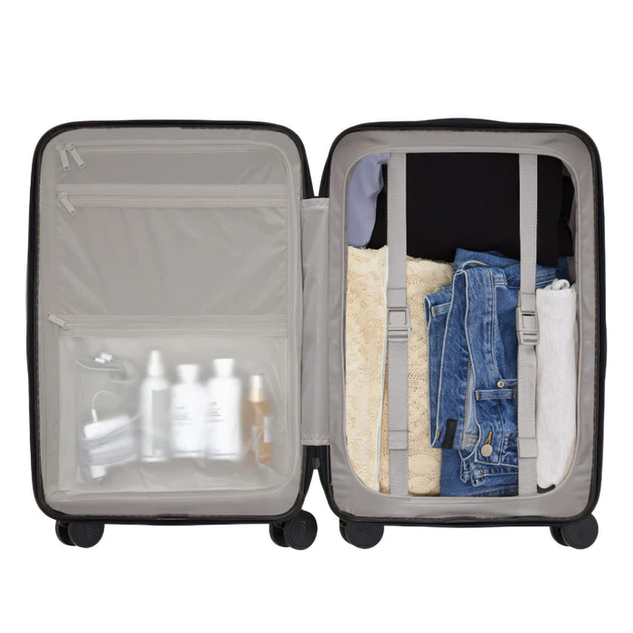 Kadi Carry-On Suitcase - Leisure - A carry-on suitcase in black with compartments for clothing and toiletries, featuring a clear zippered section.