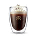Bodum Pavina Double Wall Glasses - Medium - Set of 2 - A double wall glass with a beverage topped with whipped cream and chocolate shavings, featuring a logo.