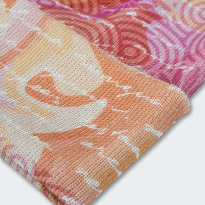 Everest Custom Full Colour Beanie - A vibrant, full-colour beanie featuring swirls of orange, pink, and white patterns, with a folded edge.